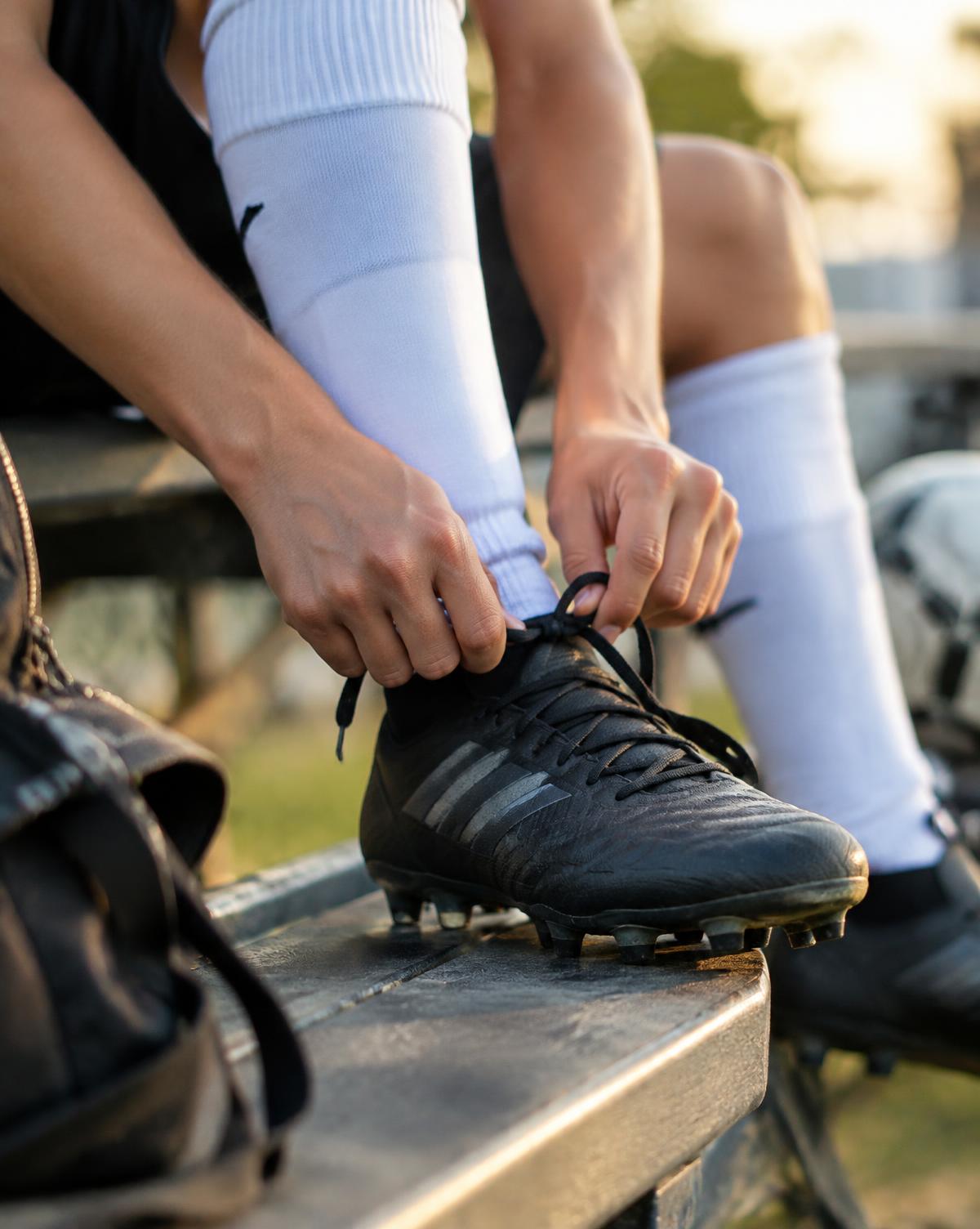 Player tying cleats before a game